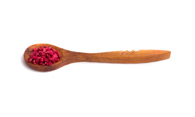 a wooden spoon with dried raspberries