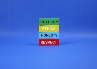 Colorful wooden blocks stacked against an blue backdrop convey core values like integrity, ethics, honesty, and respect. Ideal for concepts of character, morality, education and teamwork