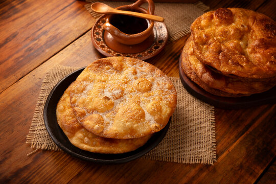 Bu&ntilde;uelos de rodilla. Traditional food at Christmas and winter holidays in Mexico, these are fried dough flour sprinkled with sugar or covered in a syrup made with piloncillo, cinnamon, and guava.