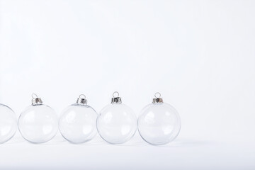 A group of clear glass ornaments are sitting on a white background