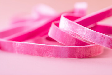 Pink velvet ribbon on soft pastel background for holiday gift wrapping concept of celebrations decorations new year christmas birthday handmade crafts
