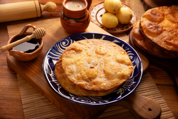 Buñuelos de rodilla. Traditional food at Christmas and winter holidays in Mexico, these are fried dough flour sprinkled with sugar or covered in a syrup made with piloncillo, cinnamon, and guava. POV