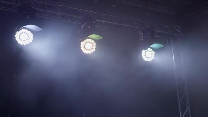 Stage lighting on metal truss with fog, color changing lights for event or performance space. Abstract