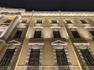 The facade of a historic building illuminated at night
