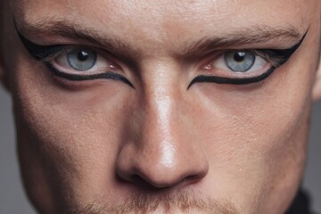 Man's blue eyes with striking black eyeliner, symbolizing gender fluidity, individuality, and self expression in beauty