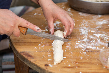 Rural Moldovan Grandma Preparing Traditional Homemade Cheese Pastry. Authentic Village Cooking....