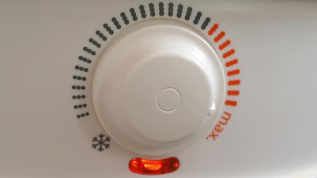 Red light indicator comes on - boiler has turned on to heat water. Regulator of temperature of heating water in boiler. Boiler heats water from cold water supply system