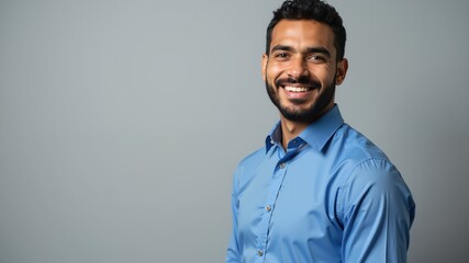 Obraz premium Confident businessman wearing blue suit, smiling at camera. Arabic style. Muslim businessman. 
