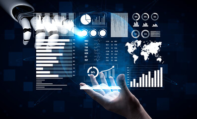 A human hand reaches out toward a robotic arm displaying complex data visualizations in a digital environment, symbolizing technology and innovation. Impute