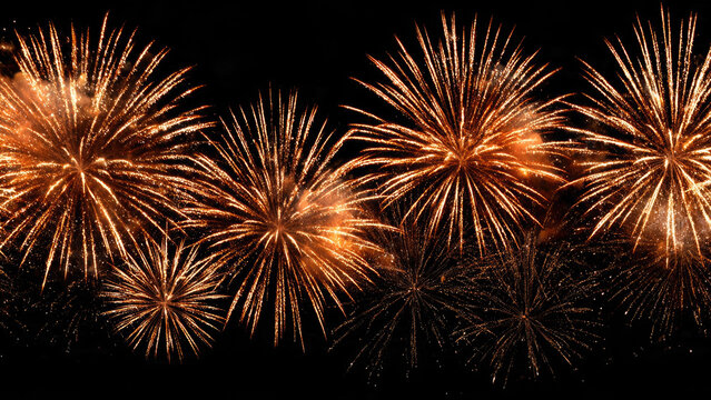 A stunning display of golden fireworks bursting across a dark night sky, illuminating the celebration with dazzling light and vibrant energy. - Powered by Adobe