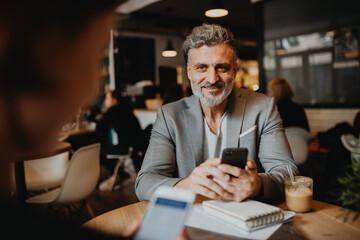 Man and woman having business meeting in a coffee shop.