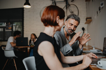 Man and woman having business meeting in a coffee shop.