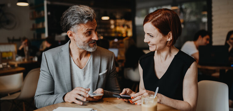 Man and woman having business meeting in a coffee shop.