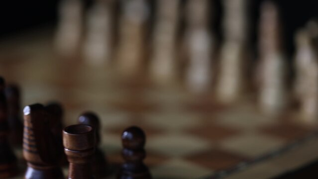 Rotating chessboard with strategically placed pieces in motion, depicting the eternal struggle between black and white factions in cerebral gameplay.