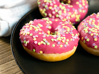 Doughnuts topped with pink cream glaze