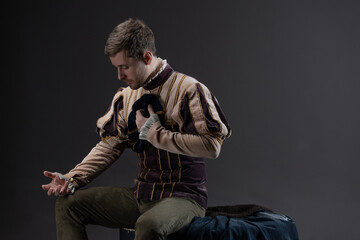 Romano, a romantic hero of a medieval setting, a young man in a costume from the early Renaissance...