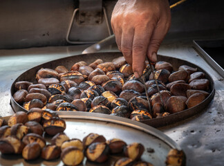 street vendor selling fried chestnuts. street foods.