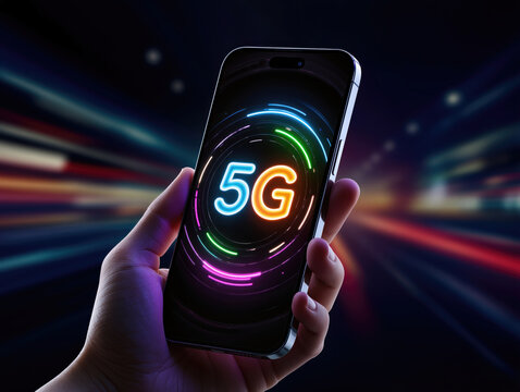 A bright 5G logo surrounded by neon rings on the smartphone held in hand. High-speed mobile technology.