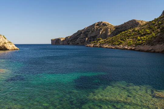 Scenic view of the rocky cliffs and crystal clear turquoise water in Calanques National Park near Marseille France in summer. - Powered by Adobe