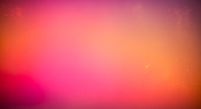 Vibrant abstract gradient background with warm pink and orange tones