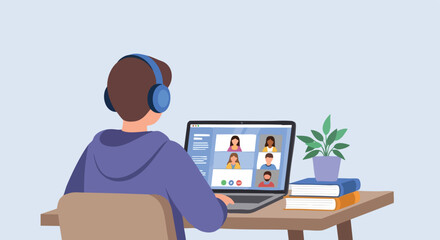 Male student wearing headphones and participating in a group video conference class or meeting on a laptop from his home desk.