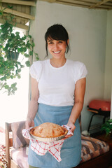 Latina woman baking apple pie at home for Thanksgiving holiday celebration. Baking homemade apple dessert for fall and winter