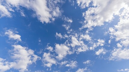 Obraz premium troposphere. Clear blue sky with fluffy white clouds creating a serene minimalistic background. travel magazines, destination branding, designed for outdoor magazines and nature guides.