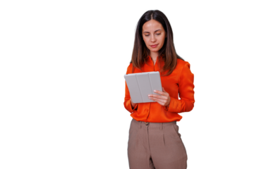 Young businesswoman standing, reading content on a portable tablet device, focusing on work, using modern technology. Transparent background