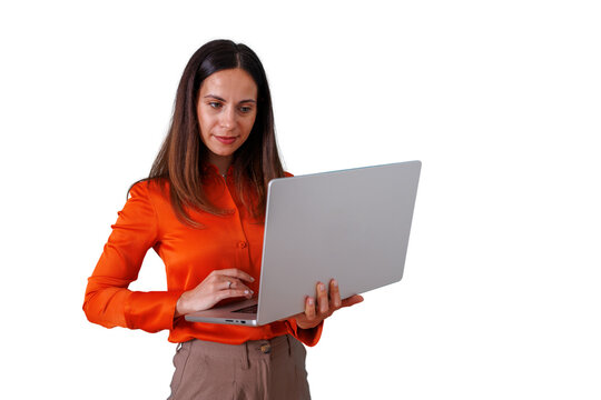 Professional woman standing, using laptop for remote work and digital communication, managing business with modern technology