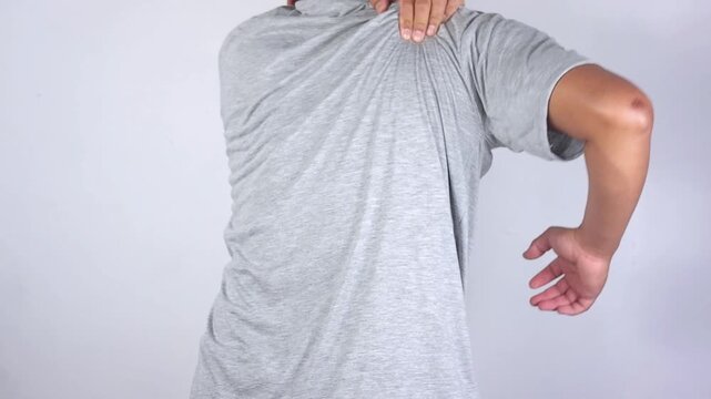 Young man suffers from neck pain along with shoulder pain, office syndrome, muscle problems, inflammation, massage, pain, muscle and tendon stress, men's health care
