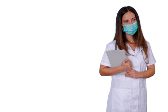 Female doctor wearing face mask holding a digital tablet with a confident expression, healthcare professional - Powered by Adobe