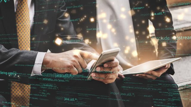 Two business professionals focus on mobile devices in a modern workspace, presenting a digital collaboration theme with programming code overlay to depict innovation. Xenic