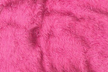 Bright pink shaggy fabric texture background. Soft, fluffy, and vibrant textile with deep pile. Ideal for abstract, cozy, or playful designs.