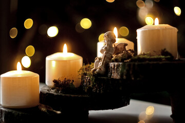 Advent wreath with four burning white candles