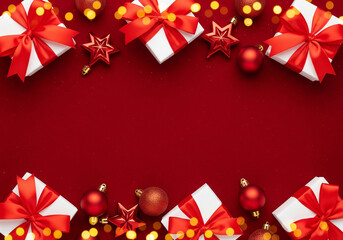 Top and bottom Christmas border on a deep red background with white gifts tied with red bows, scattered red ornaments, star decorations, and golden bokeh lights creating open central space.