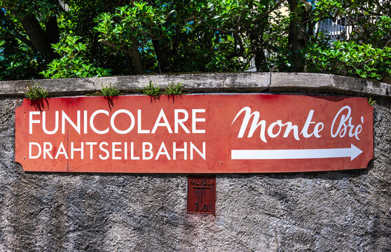 Lugano, Switzerland - July 9, 2025: Signage indicating the valley station of the cable car station for Monte Bre in Lugano Cassarate, Ticino.