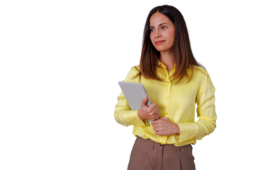 Confident young woman in a yellow shirt holding a tablet, standing with a pensive look, digital technology