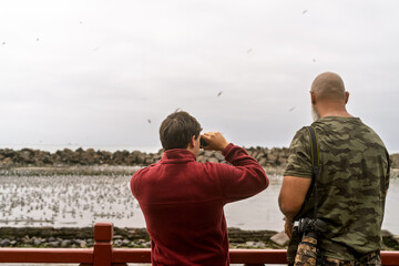 Men enjoying bird watching and wildlife photography