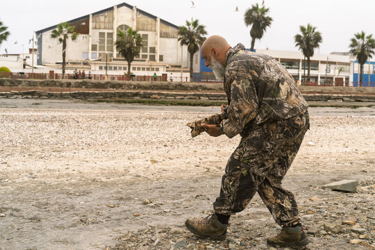 Man observing birds with camera in wetland habitat - Powered by Adobe