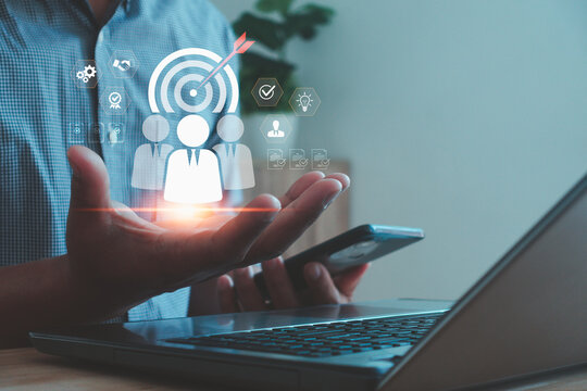 A business concept image showing digital customer targeting with user icons and a dartboard, representing marketing strategy, audience segmentation, data analysis and customer engagement technology.