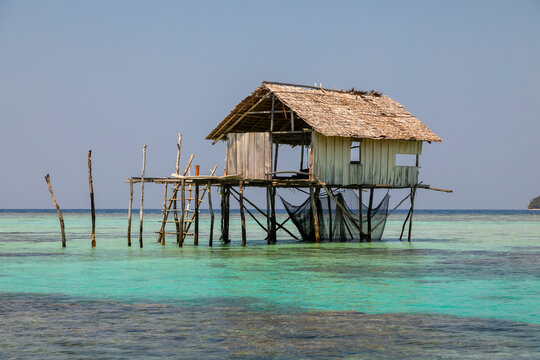 A rudimentary hut on the water, supported by logs, used as a shelter by fishermen and inhabitants of the Togian Islands, Sulawesi, Indonesia