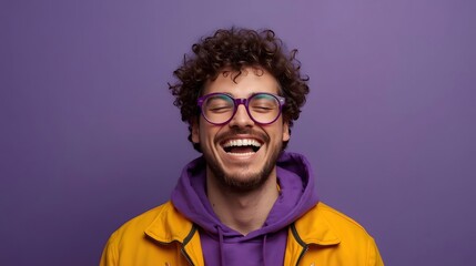 Vibrant portrait of a joyful young adult wearing colorful clothing and stylish glasses, captured against a bold purple background with expressive laughter and energetic modern fashion vibes