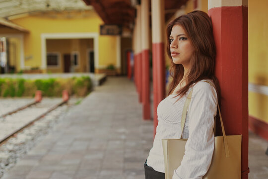 Young woman waiting at train station platform.World Fashion Day