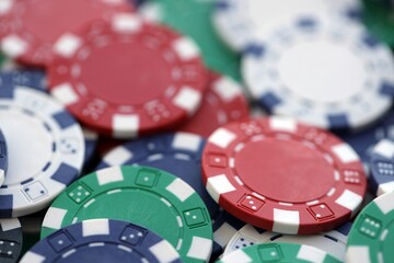 Close up of a group of casino chips on a green mat for poker or dice games indoors