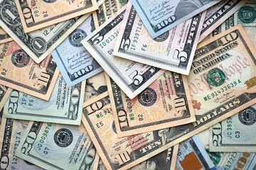 Big amount of different dollar bills close up. Hundred fifty twenty ten and five dollar banknotes