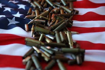 Bullets with USA flag in dark light. Patriotic background image with ammo and United States flag