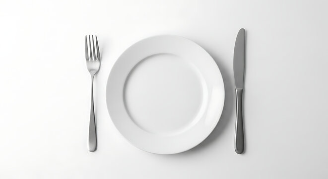 A pristine white plate is flanked by a fork and knife on a white surface. - Powered by Adobe