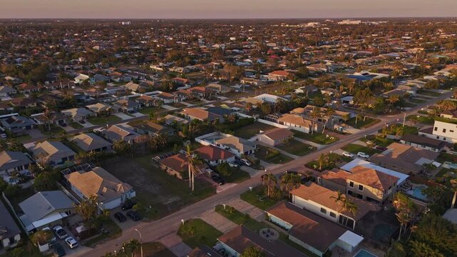 Sunset aerial of Naples Florida residential neighborhood with single family homes and quiet streets