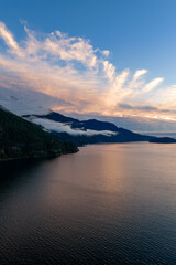 Tranquil Sunset Over Howe Sound With Mountain Peaks And Misty Clouds In Coastal BC