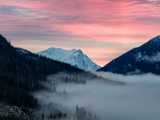 Serene Mountain Sunset Over Foggy Valley With Snow-Capped Peaks In BC, Canada